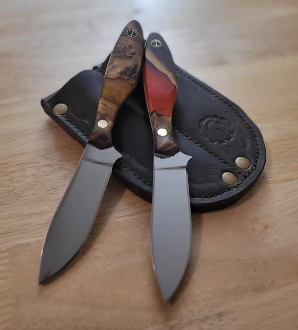 RRK-01-002 and 003, a pair of small skinning knives with amber and red burl handles, on a hand-stitched double leather sheath