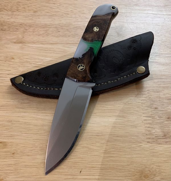 RRK-01-005, mirror-polished blade with dark burl scales and vivid green resin inlay, on a stamped leather sheath
