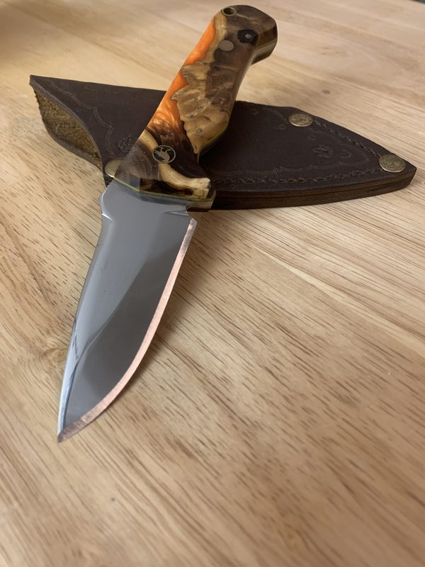RRK-01-006, gently curved blade with warm orange Russian olive burl scales, displayed on its hand-stitched leather sheath