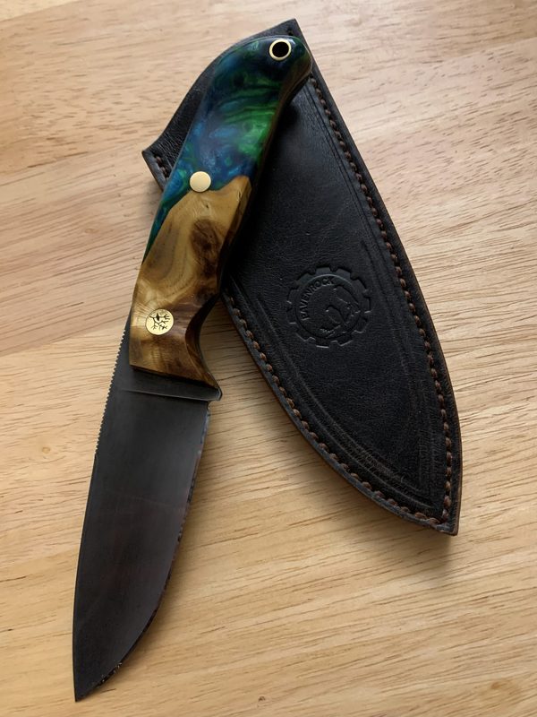RRK-01-009, acid-etched dark blade with blue-green resin and burl handle, leaning on its leather sheath