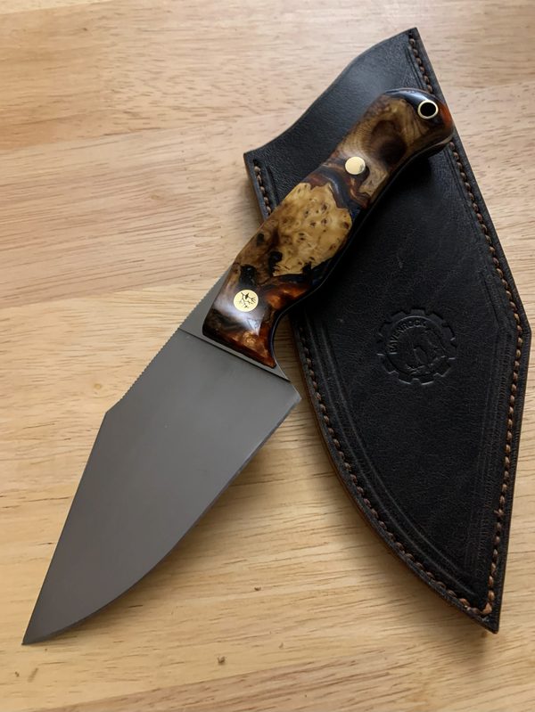RRK-01-011, dark blade with deep amber burl handle, on its dark leather sheath
